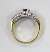 A modern 18ct gold and single stone oval cut garnet? dress ring, with two row diamond set shoulders, size N, gross weight 5.2 grams.